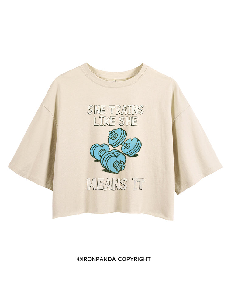 SHE TRAINS LIKE SHE MEANS IT FUNNY GYM CROP TOPS