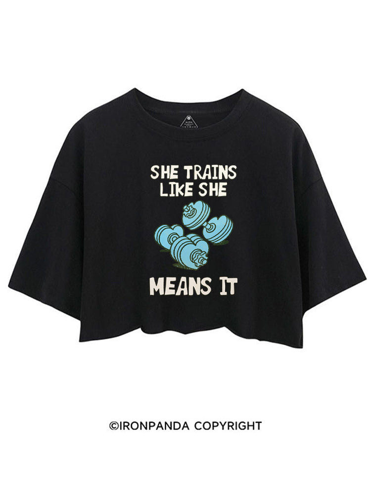 SHE TRAINS LIKE SHE MEANS IT FUNNY GYM CROP TOPS