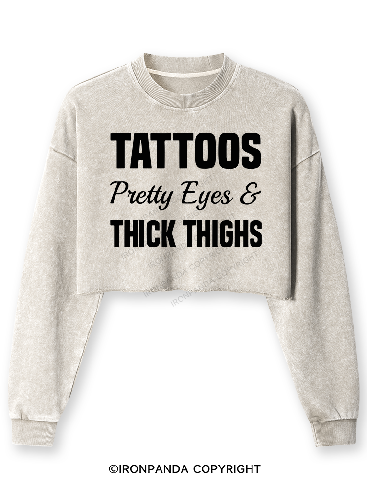 TATTOOS PRETTY EYES AND THICK THIGHS Washed Long-Sleeve Crop Top