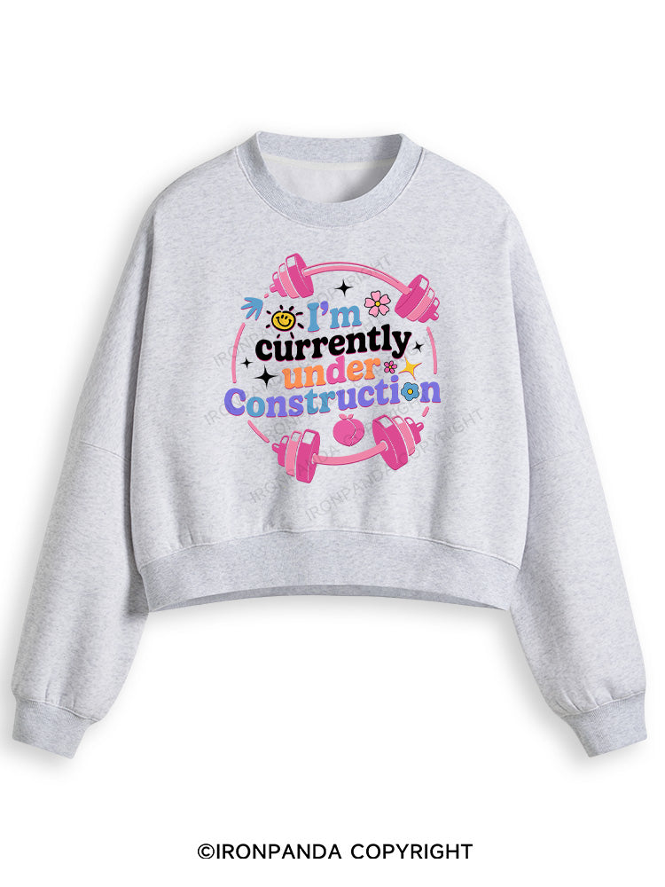 I'M CURRENTLY UNDER CONSTRUCTION Fleece Crop Sweatshirt