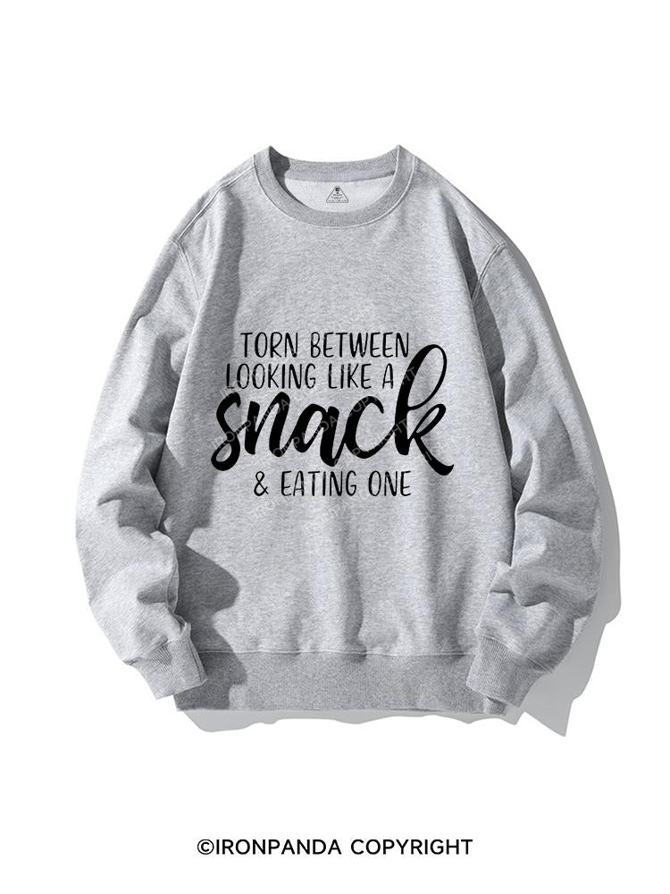 TORN BETWEEN A SNACK AND EAT ONE CREWNECK Sweatshirt